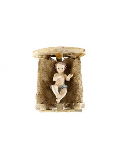 Niño Jesús con cuna de madera.
Representación del Niño Jesús, realizado en resina, en cuna de madera, fondo de paja y tela de 
